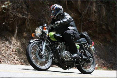 1985 Ford LTD Crown Victoria - Rider on a classic Honda motorcycle navigates a winding road.
