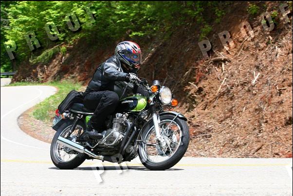 Green Honda motorcycle on a winding road