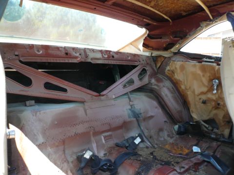 1975 Ford Ranchero - The interior of a vehicle appears to be undergoing restoration, with much of its original trim removed.