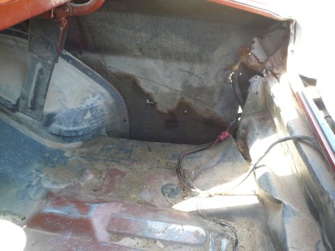 1975 Ford Ranchero - The trunk interior shows signs of rust and exposed wiring.