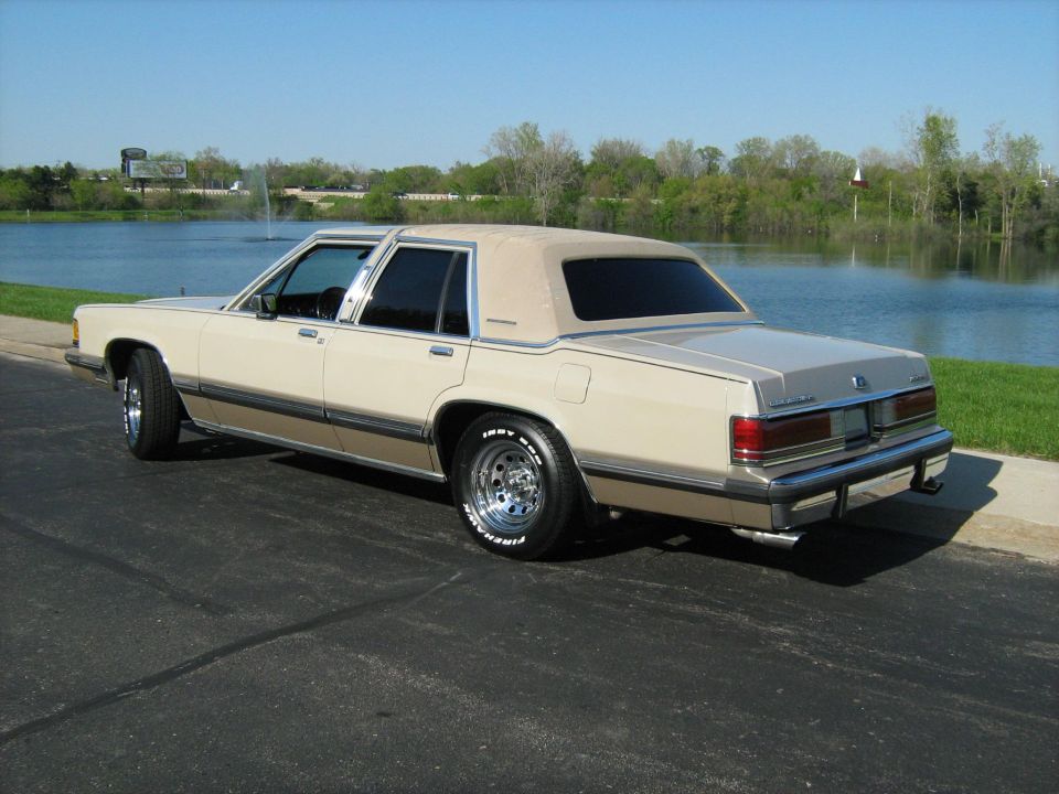 1988 Mercury Grand Marquis sedan, tan and brown, parked by a lake