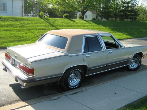 1988 Mercury Grand Marquis - Rear three-quarter view of a 1988 Mercury Grand Marquis sedan parked on a residential street.