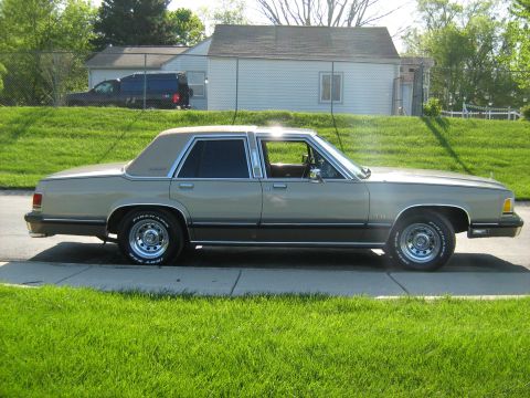 1988 Mercury Grand Marquis - This 1988 Mercury Grand Marquis is seen from the side, parked on a suburban street.