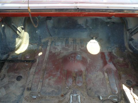 1975 Ford Ranchero - The cargo area of the vehicle is visible, showing its floor and the surrounding metal structure.