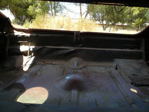 1975 Ford Ranchero - The cargo area of a 1975 Ford Ranchero shows its bare metal floor and rear wall.