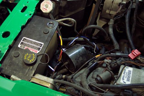 2001 Ford Crown Victoria - Close-up of an engine bay, showing a washer fluid reservoir and electrical components.
