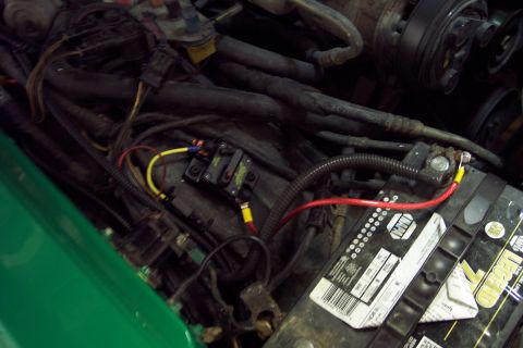 2001 Ford Crown Victoria - Close-up view of a car's engine bay, showing the battery and electrical wiring.