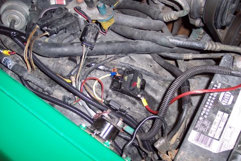 2001 Ford Crown Victoria - Wiring and components in a vehicle's engine bay, including a battery and circuit breaker.