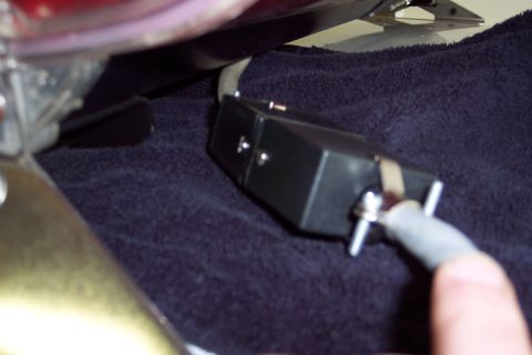 2001 Ford Crown Victoria - A close-up view of an aftermarket electronic component installed on a vehicle's chassis.