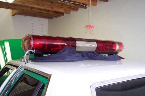 2001 Ford Crown Victoria - Close-up of a police light bar mounted on the roof of a vehicle.
