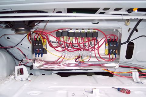 2001 Ford Crown Victoria - Custom wiring setup with relays and fuse blocks installed inside a vehicle.