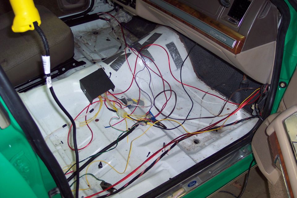2001 Ford Crown Victoria interior with exposed wiring and a black control box