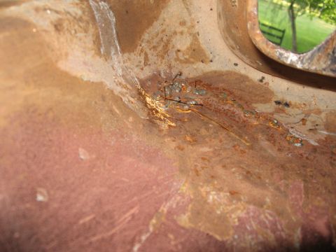 1966 Ford F-100 - A detailed view of a damaged metal component, showing signs of rust and repair work.