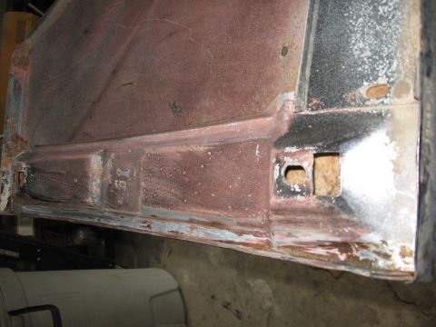 1966 Ford F-100 - This close-up shows a section of a vehicle's body panel, exhibiting rust and primer.
