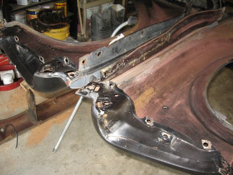 1966 Ford F-100 - Car parts, including a fender and brackets, are laid out on a concrete floor, possibly for restoration.