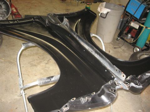 1966 Ford F-100 - Car fenders are mounted on a stand, possibly for repair or painting.