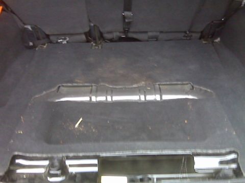 2008 Jeep Wrangler - The cargo area floor of a vehicle with the rear seats folded down.