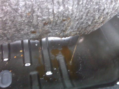 2008 Jeep Wrangler - The interior floor of a vehicle shows signs of moisture and staining, indicating a potential leak.