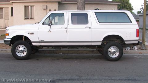 1996 Ford C-350 (Centurion Conversions) - This lifted pickup truck features an extended cab and a custom camper shell, giving it an SUV-like profile.