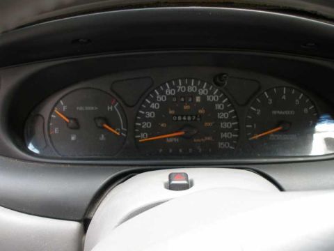 1997 Ford Taurus - Vehicle gauge cluster showing speedometer to 150 MPH, tachometer and an odometer reading 084877 miles.