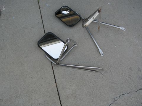 1986 Ford Bronco - Pair of side mirrors with chrome mounting hardware on a concrete surface.