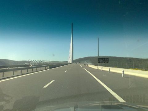 1991 Ford LTD Crown Victoria - View from a vehicle driving on a highway towards a distinctive bridge structure.