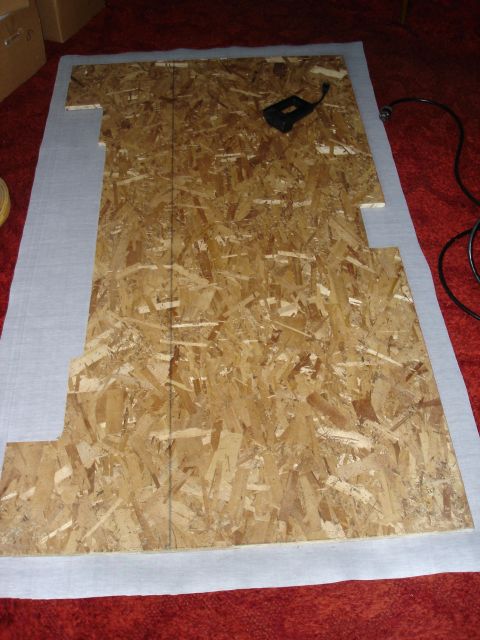 1995 Ford Bronco - A custom-shaped wood panel is prepared, possibly for a vehicle interior modification.