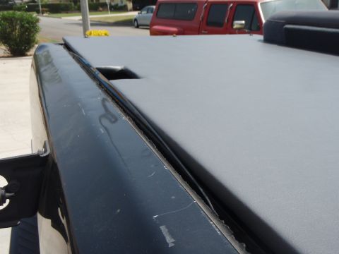 1995 Ford Bronco - A close-up view of a truck's tonneau cover reveals its textured surface and some signs of age.