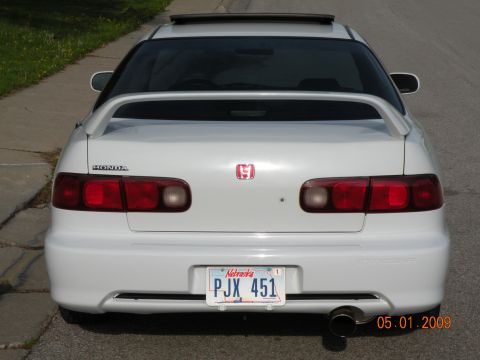 1994 Acura Integra - This 1994 Honda Integra features a rear spoiler and a sunroof, seen from a rear-facing perspective.