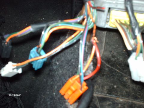 1995 Ford Probe - Close-up of a vehicle's interior wiring harness, showing various colored wires and connectors.