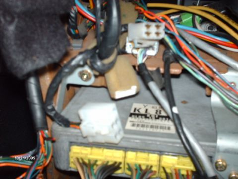1995 Ford Probe - Interior view of a car's complex wiring harness and electronic control module, showing many colorful wires.