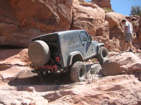 1986 Ford Bronco II - A Jeep Wrangler TJ tackles a difficult off-road course in a rocky canyon.