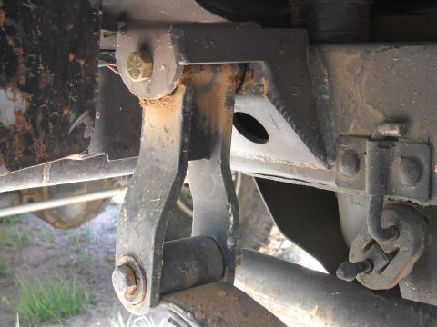 1986 Ford Bronco II - Undercarriage view of a vehicle's suspension system, showing metal components with visible rust and dirt.
