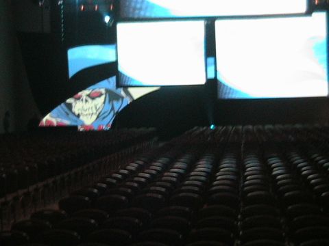 1966 Ford Bronco - A stage setup with multiple screens displaying graphics, viewed over rows of empty seats.