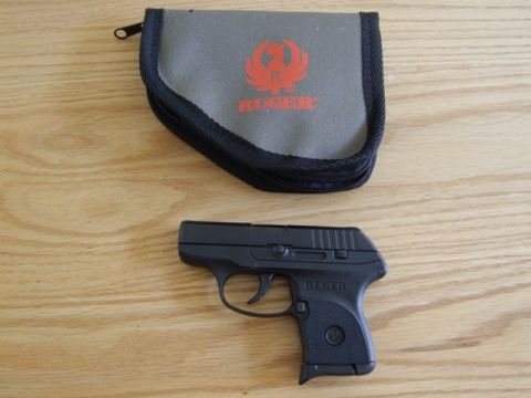 2002 Jeep TJ - Ruger LCP pistol and its carrying case are displayed on a wooden table.