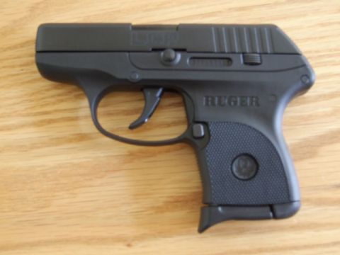 2002 Jeep TJ - A black Ruger LCP handgun is shown from the side on a wooden surface.
