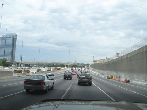 1995 Ford C-350 (Centurion Conversions) - A view from a vehicle on a busy highway with multiple lanes of traffic and ongoing construction.