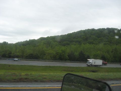 1995 Ford C-350 (Centurion Conversions) - A white box truck displaying a GE logo is seen driving on a highway alongside a red pickup truck.