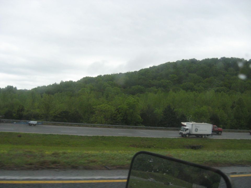 White box truck with GE logo and red pickup truck on highway