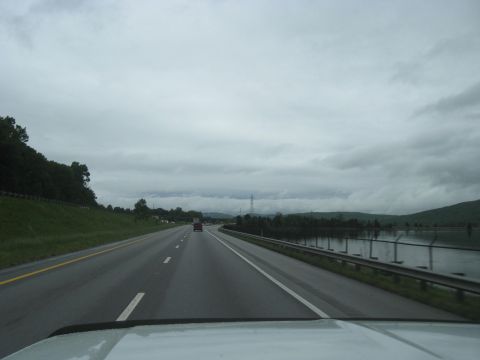 1995 Ford C-350 (Centurion Conversions) - View from a vehicle traveling on a highway during overcast weather, with a distant car visible.