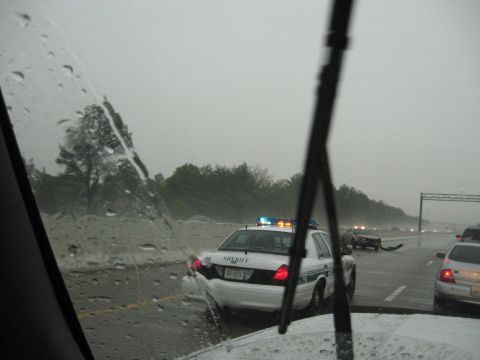 1995 Ford C-350 (Centurion Conversions) - A sheriff's car is parked on the highway in the rain, responding to an accident ahead.