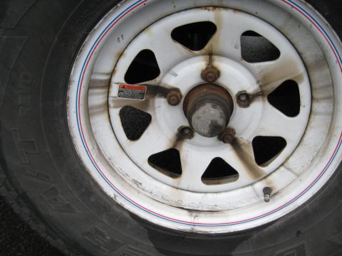 1995 Ford C-350 (Centurion Conversions) - Trailer wheel and tire detail, with visible 'REVO' branding on the tire sidewall.