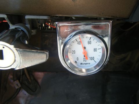 1979 Ford Bronco - Close-up of an aftermarket Sunpro oil pressure gauge installed in a vehicle's interior.