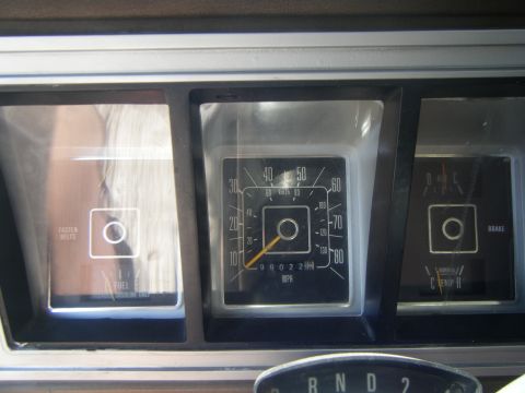 1979 Ford Bronco - Dashboard gauges of a 1979 Ford Bronco, including fuel, speedometer, and brake warning indicators.