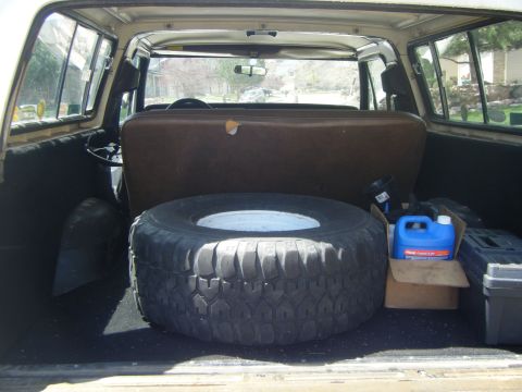 1979 Ford Bronco - Spare tire and supplies stored in the cargo area of a vehicle.