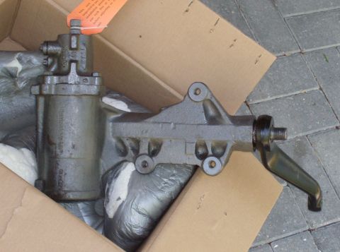 1989 Ford Bronco - A close-up view of a power steering gearbox, likely a replacement part, resting in a cardboard box.