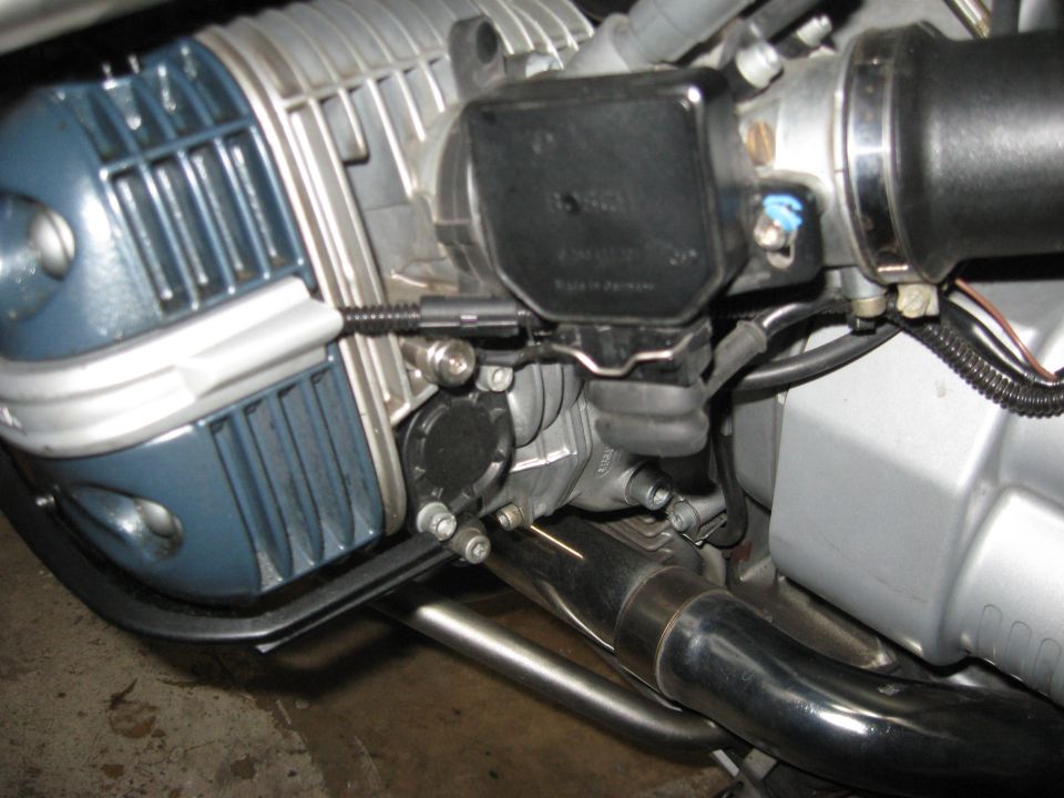 Left side cylinder showing negative gound plug for jump starting.

Note 12 o'clock position of bolt pattern at top of black plastic cover.
