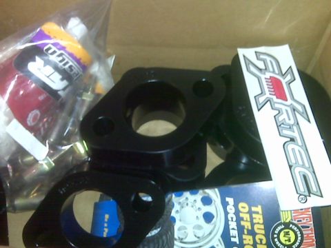 2008 Jeep Wrangler - A box containing automotive lift kit components, including black spacers and a branded sticker.