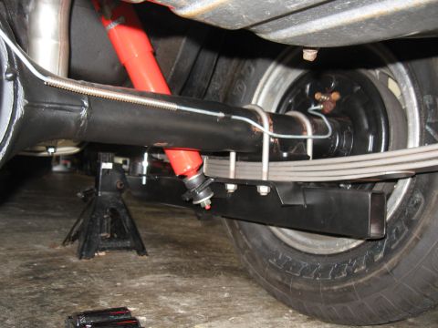 1968 Shelby GT500 - Close-up view of a vehicle's rear suspension system, including the axle, shocks, and leaf springs.