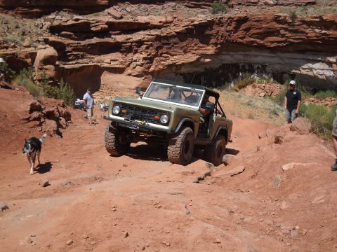 1986 Ford Bronco II - First-gen Ford Bronco tackling a challenging off-road course in a desert landscape.